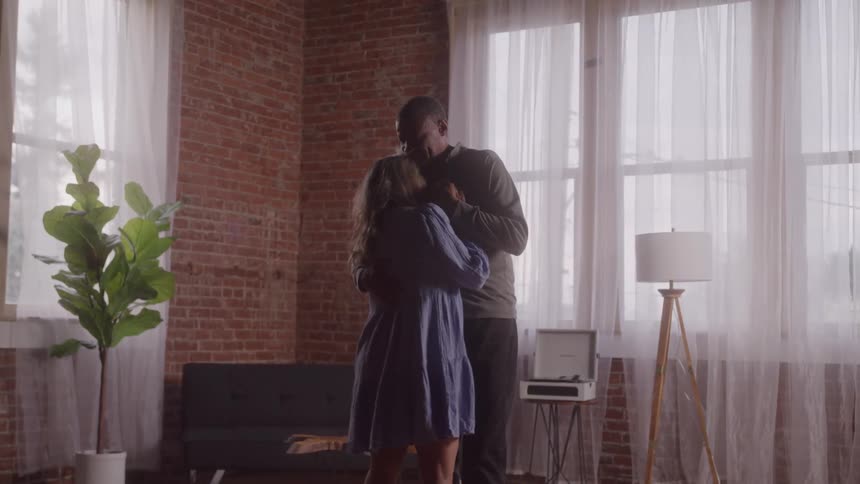Couple dancing romantically in a room