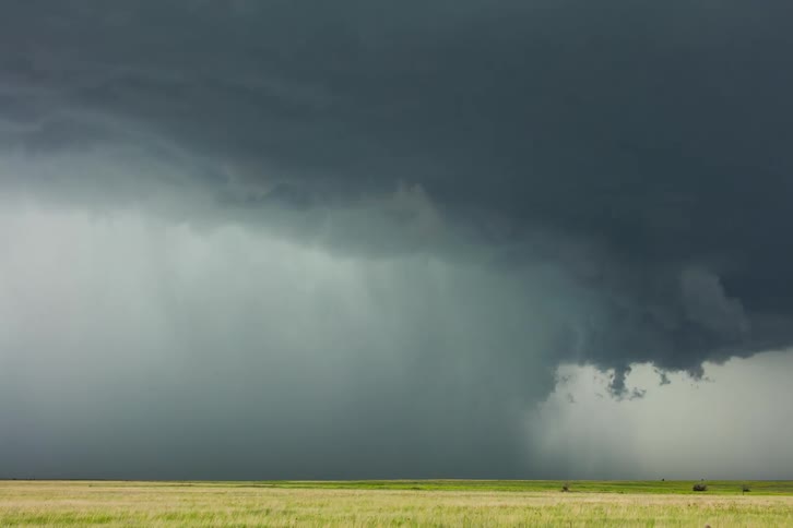 Dark storm cloud over open plains