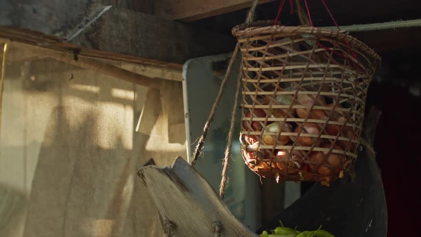 Hanging wicker basket containing onions