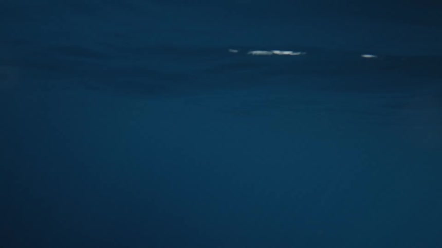Calm ocean surface under a cloudy sky