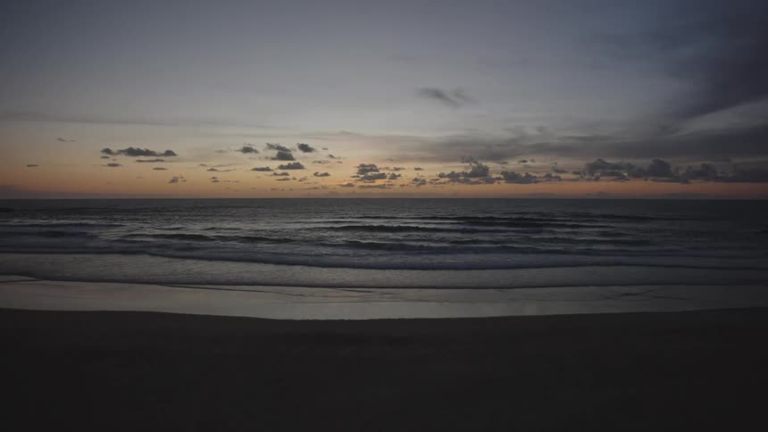 Calm beach under a colorful sunset sky