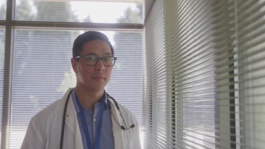 A doctor looks at the camera