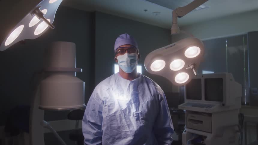 A surgeon looks at the camera