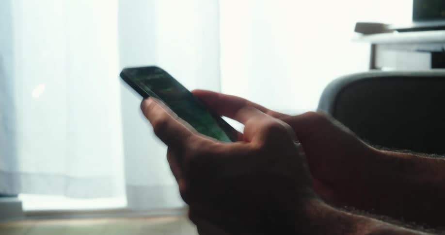 Person holding and using a smartphone