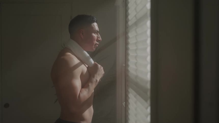 A man is looking out the window