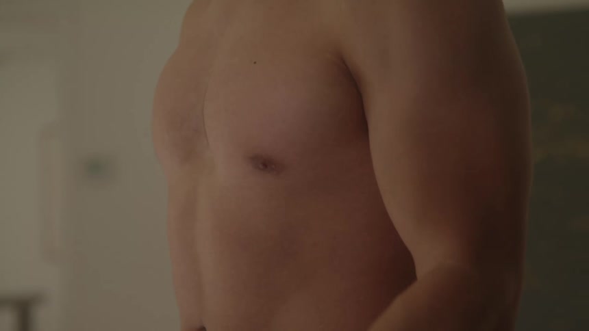 Shirtless man doing dumbbell press