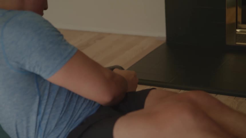 Man with dumbeel doing situps
