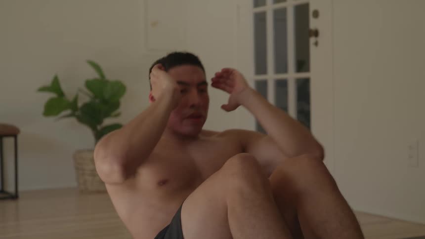 Man doing situps without a shirt