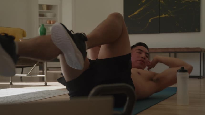 Man doing crunches on an exercise mat
