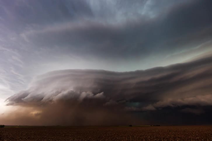 A massive tornado churns across open plains