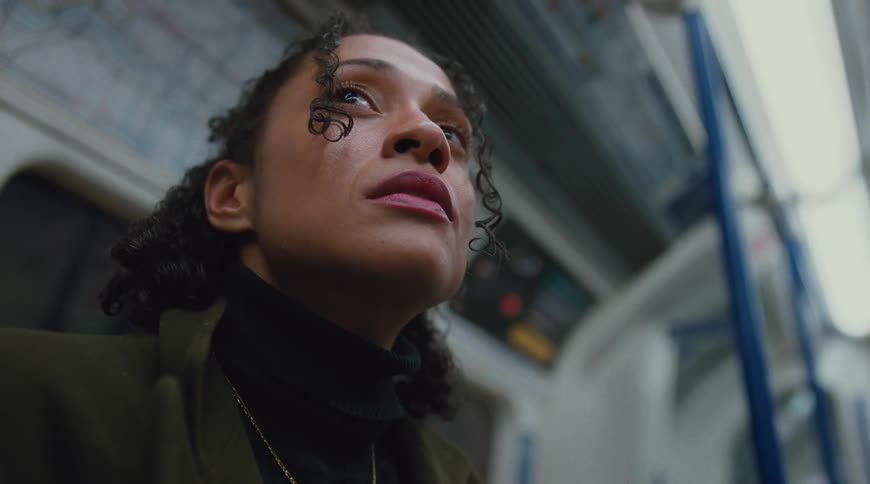 Woman looking up inside a subway car