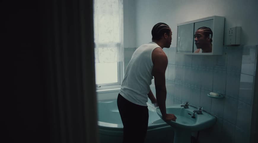 Man washes his face in a bathroom