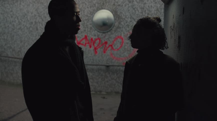 An upset couple is arguing in an underpass