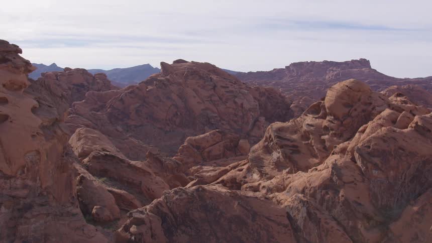 Reddish rock formations in a mountainous landscape