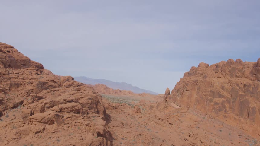 Orange rock formations under a partly cloudy sky