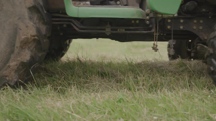 Green tractor wheels on the grass