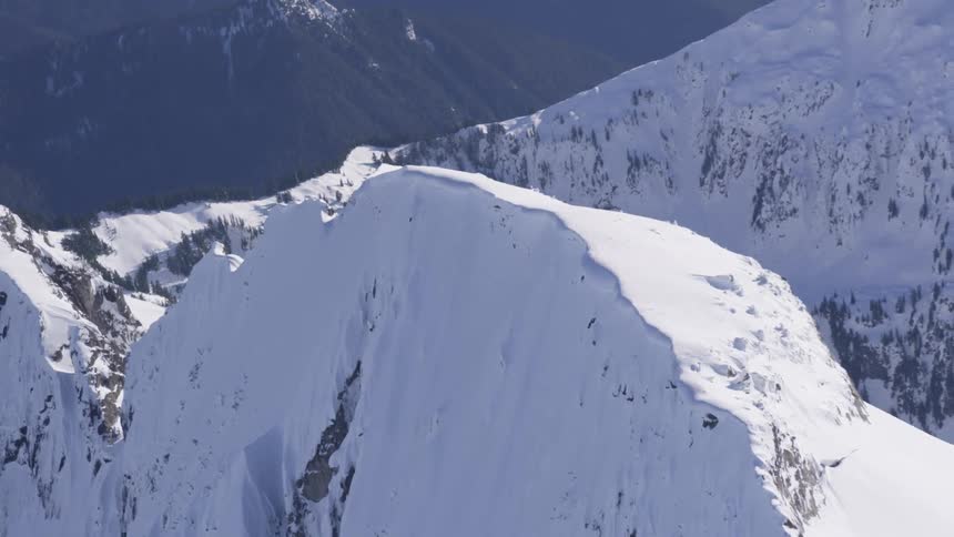 Snowcovered mountain summit with steep slopes