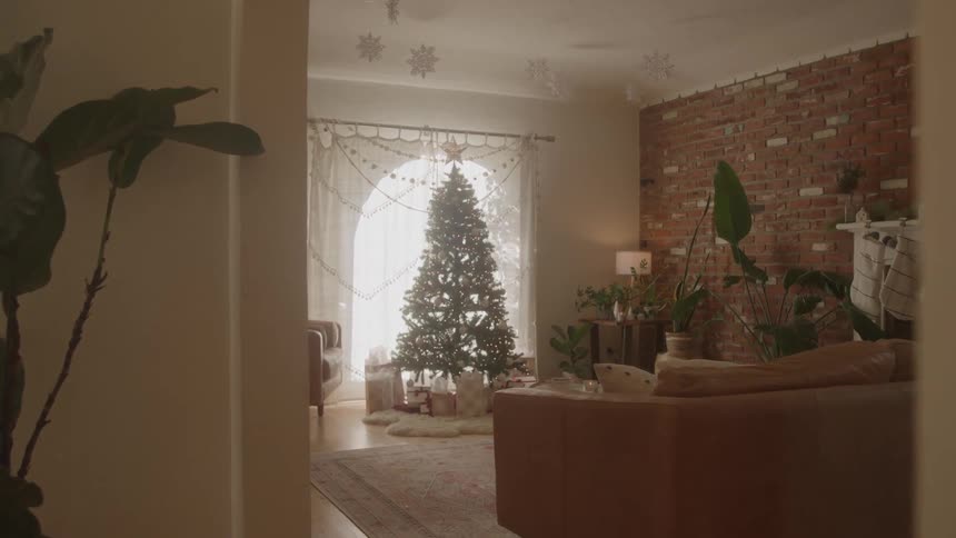 Christmas tree surrounded by gifts in a living room