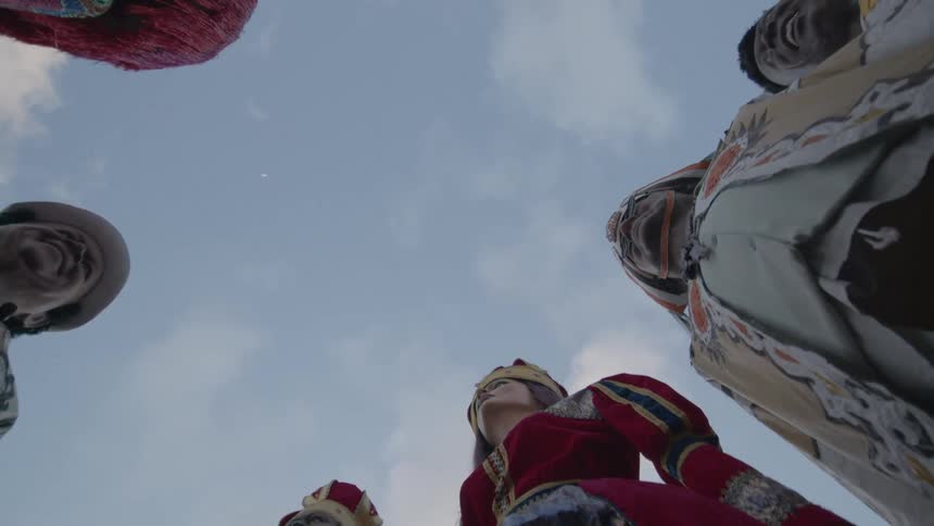 People perform in traditional costumes at a cultural festival