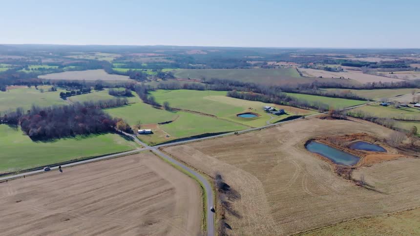 Aerial view of rural farmland with fields and ponds