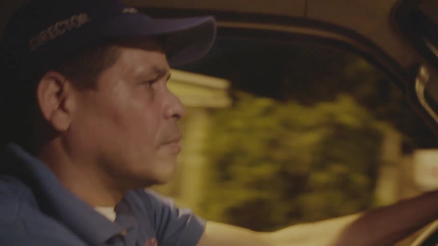 A man is driving a car at night