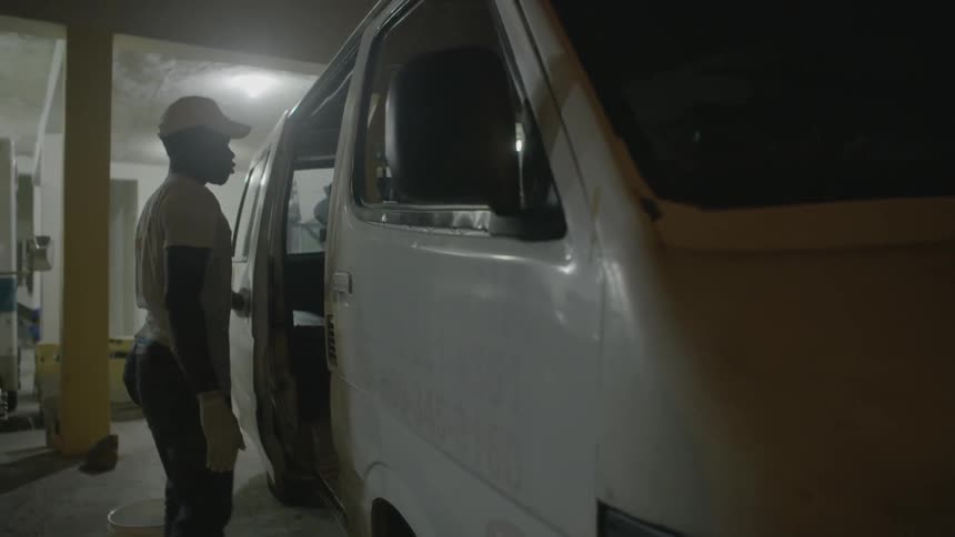 A man closes the door of his van