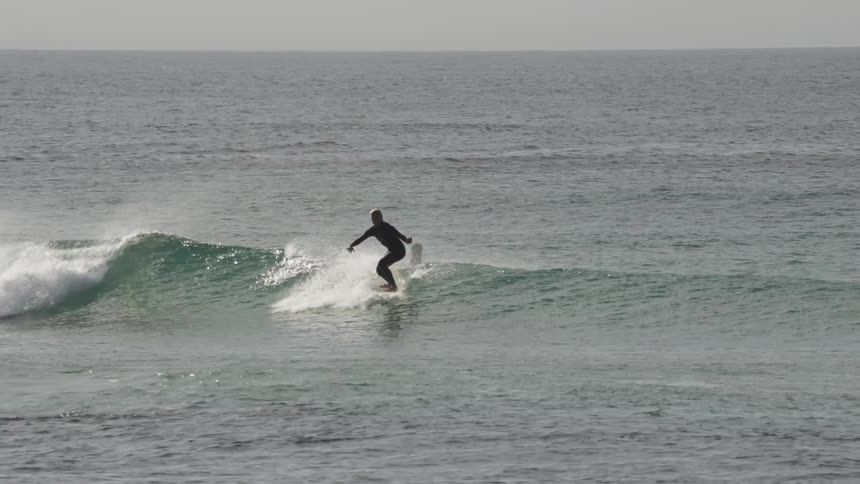 Two people are surfing on ocean waves together
