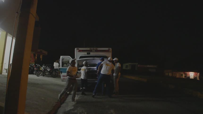 A group of men are working to repair an ambulance