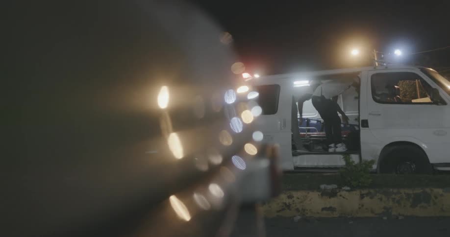 Paramedics looking through an ambulance