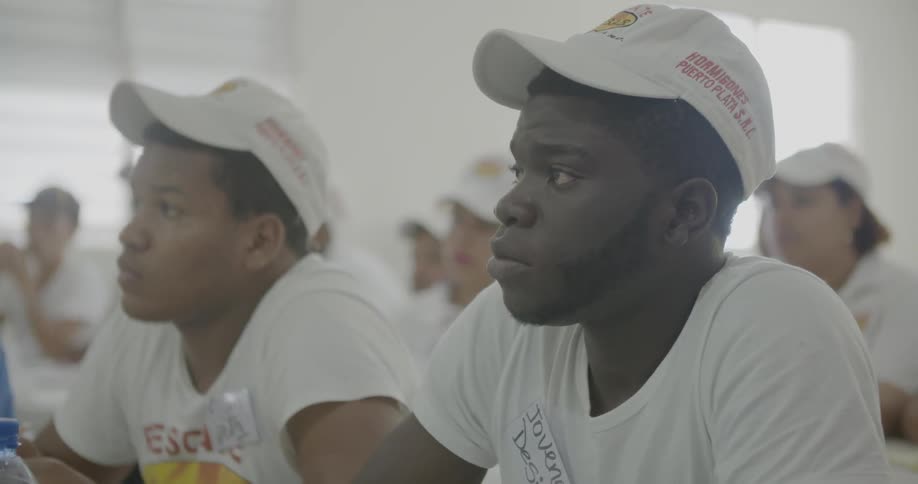 Two men wearing hats in a classroom