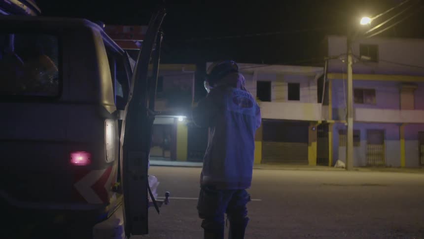A firefighter stands near an ambulance