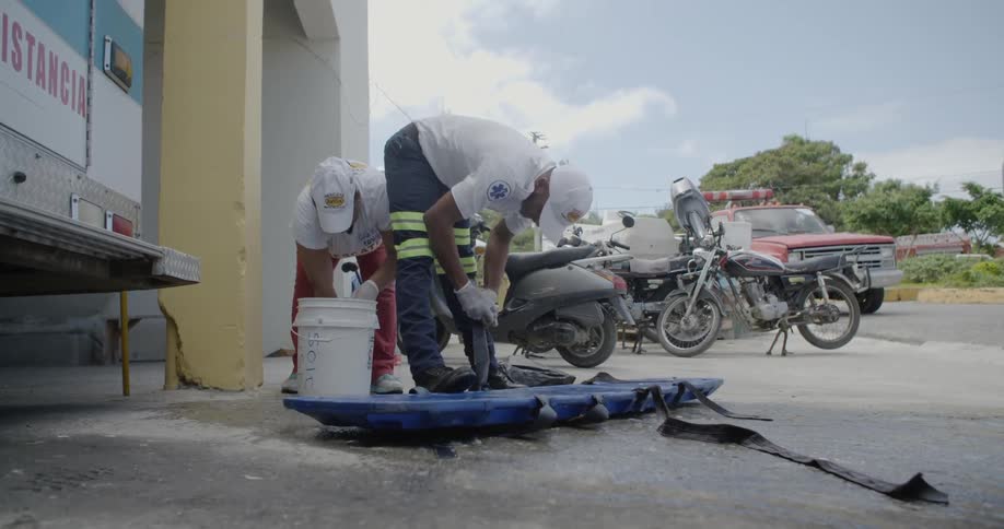 Two workers scrub equipment