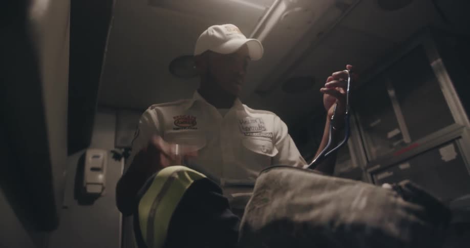 A paramedic puts on a stethoscope