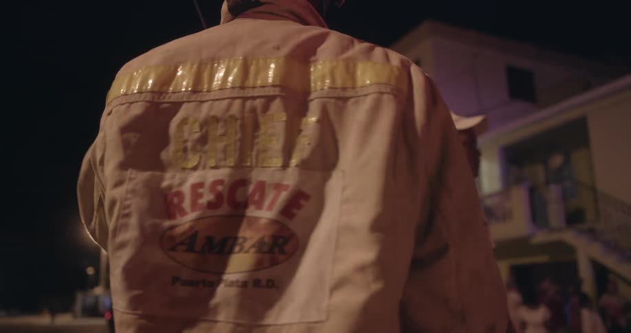 Flashing lights shine on the back of a fire chief