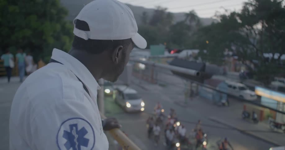 An emt worker looks below over a scene