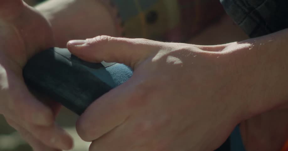 The man tightens the latch on his shoe