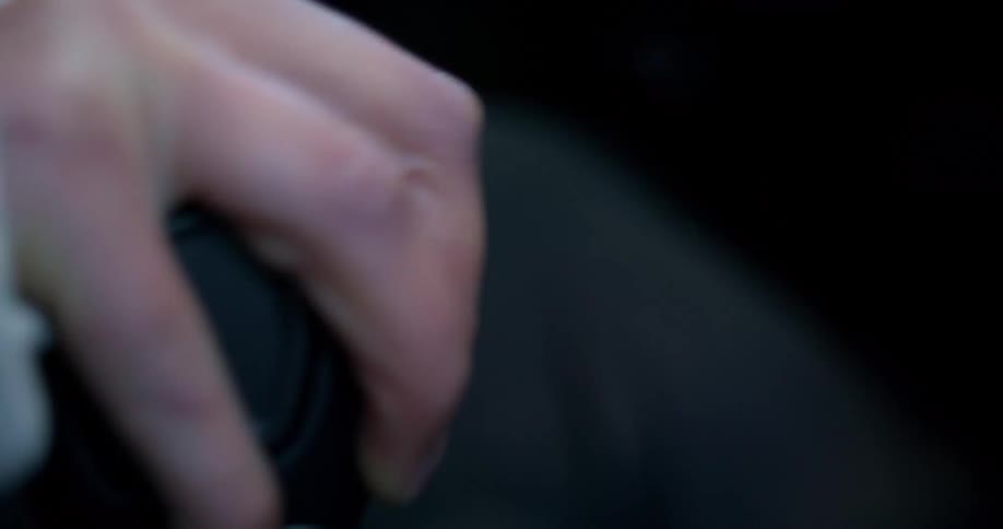 A man pulls the gear shift in the car