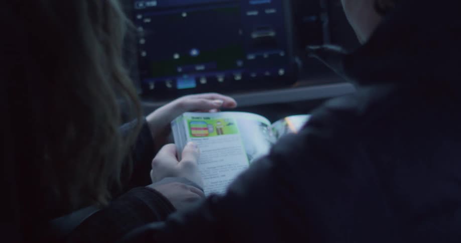 Two people look at a map while on a road trip