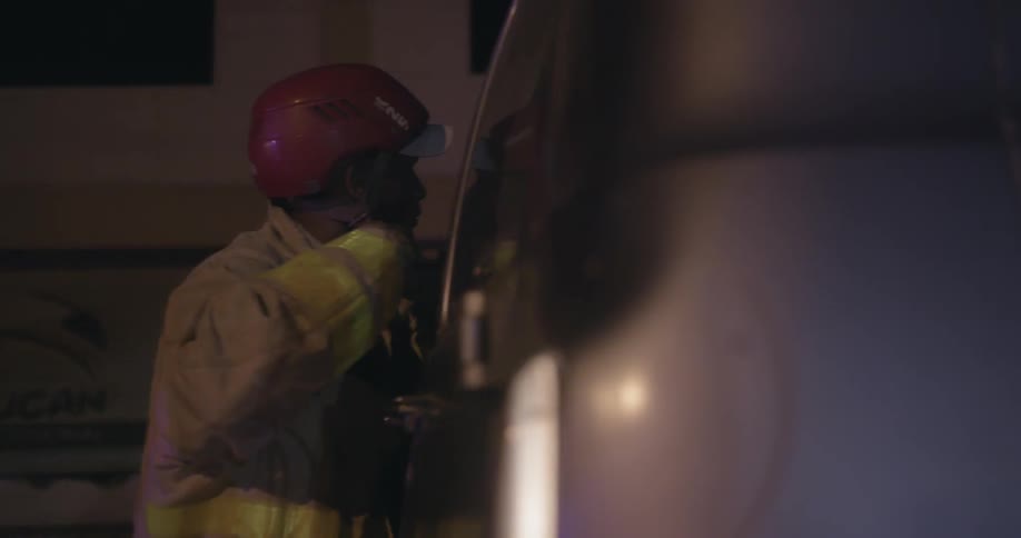 A firefighter clips his helmet on