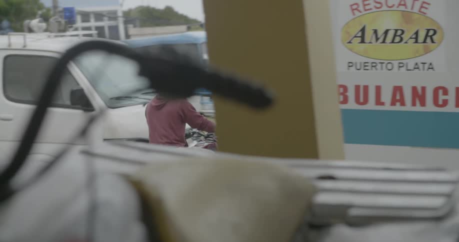 A man rides a motorcycle in a town
