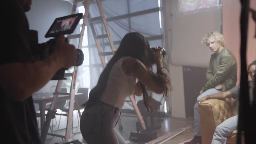 A photographer captures models on set