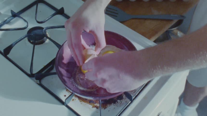A man is frying eggs