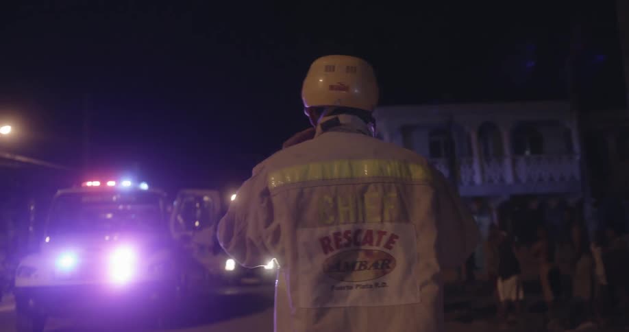 A fireman is putting on his helmet