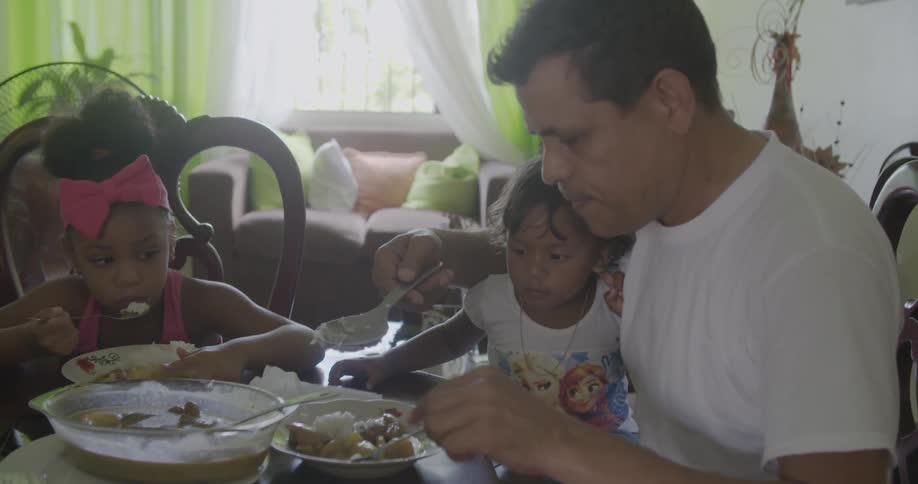 A family eats at a dinner table