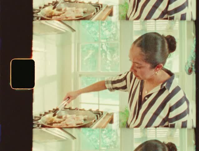 Woman cooking at a stove in a bright home kitchen setting