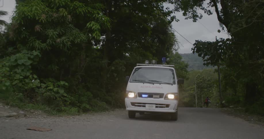An ambulance drives down a rural road