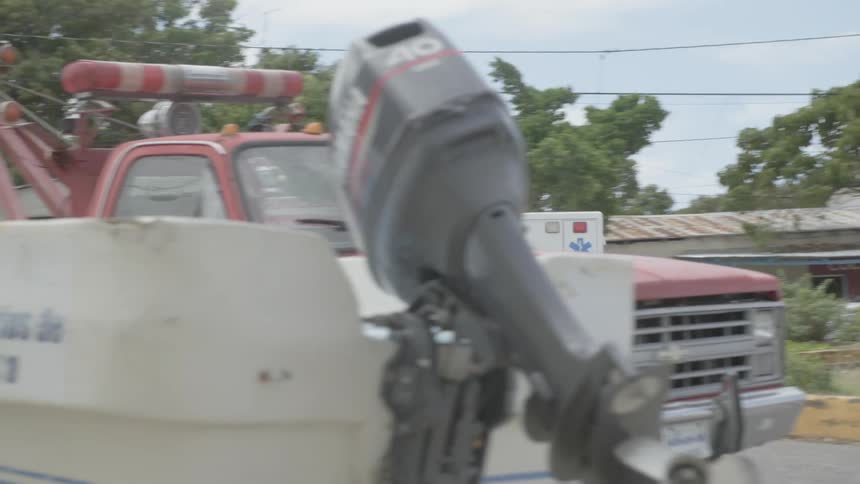 An ambulance speeds off with its lights flashing