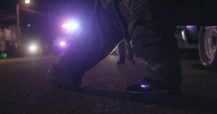 Emergency workers work with lights flashing