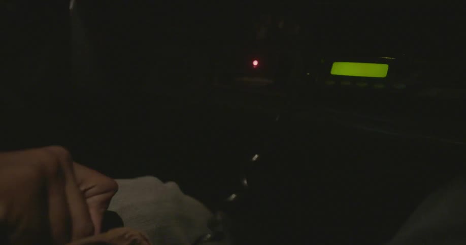 A man is changing the gears in a vehicle