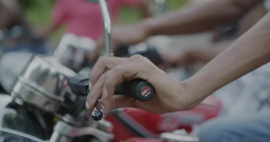 A man revs the throttle on a motorcycle